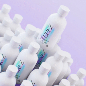 A group of small white BREZ Cannabis & Mushroom Infused Shot Bottles with a purple background.